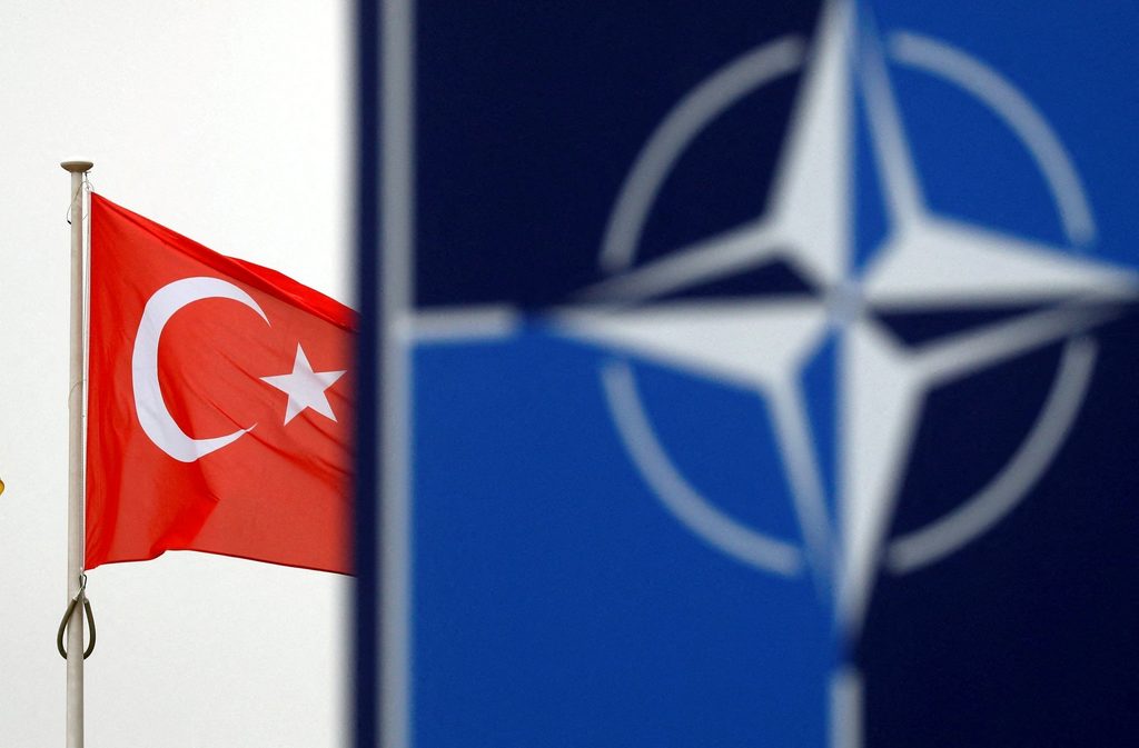 Turkish flag and NATO emblem representing Türkiye and NATO Article 5